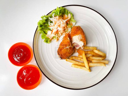 Crispy creamy chicken cordon bleu with french fries and sauce