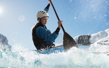 Photo for Woman in a kayak sails on a mountain river. Whitewater kayaking, - Royalty Free Image
