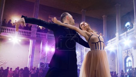 Couple dancers perform waltz on large professional stage. Ballro