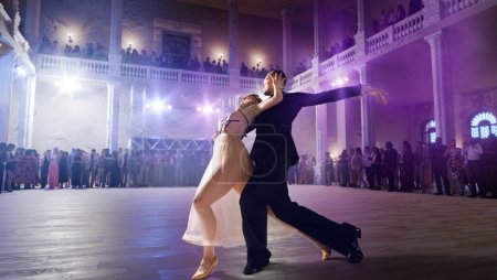 Couple dancers perform waltz on large professional stage. Ballro
