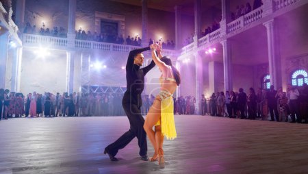 Photo for Couple dancers  perform latin dance on large professional stage. - Royalty Free Image