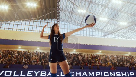 Photo for Female volleyball player in action on professional stadium. - Royalty Free Image