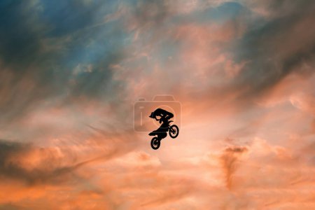 Photo for FMX rider performs dangerous stunts at sunset - Royalty Free Image