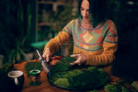 Photo for Young woman in workshop making Christmas toys - Royalty Free Image