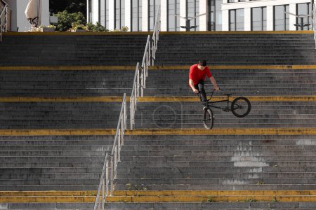 Photo for Ukrainian bmx rider performing tricks in the middle of the city. - Royalty Free Image