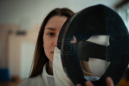 Photo for Fencing sport. Beauty female fencer training in hall. - Royalty Free Image