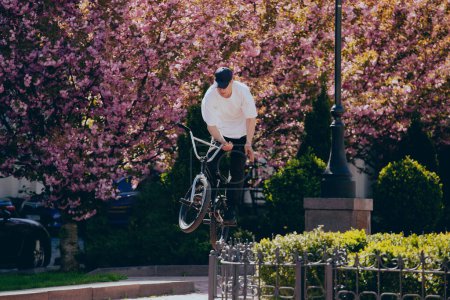 Photo for BMX rider performing tricks on street - Royalty Free Image