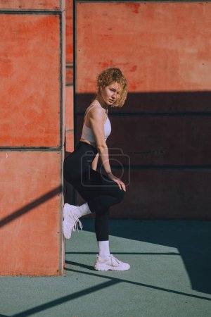 Photo for A young woman is doing sports outdoors - Royalty Free Image