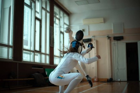 Photo for Fencing sport. Two girl fencers training in hall. - Royalty Free Image