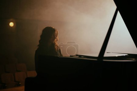 Photo for The woman playing the piano in the concert hall - Royalty Free Image
