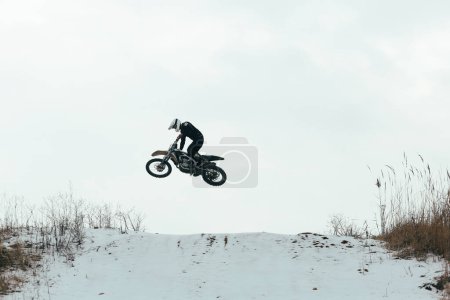 Photo for Man performing a great trick for beginner FMX rider - Royalty Free Image
