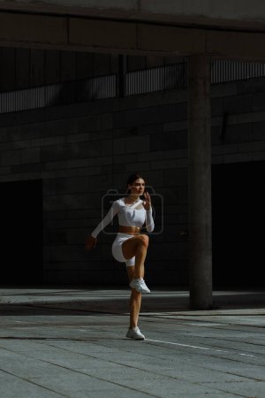 Photo for Sporty girl performing with functional training on the street. - Royalty Free Image