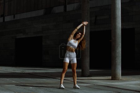 Photo for Sporty girl performing with functional training on the street. - Royalty Free Image