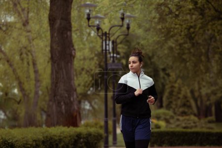 Photo for Outdoor female boxer training in morning park - Royalty Free Image