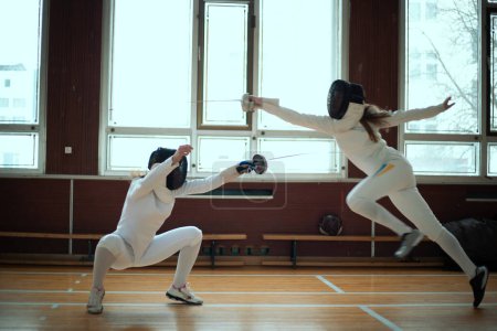 Photo for Fencing sport. Two girl fencers training in hall. - Royalty Free Image