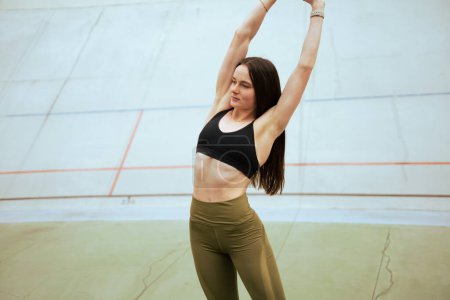 Photo for Young Athletic girl Exercising  in stadium. - Royalty Free Image