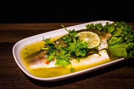 Photo for Thai Steamed Seabass fillet with Lime and Chilli and topped with special sauce. - Royalty Free Image