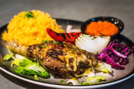 Photo for Main Course of Lamb Mandi served with basmatic rice, grilled chilli, tomato, lettuce, red cabbage - Royalty Free Image