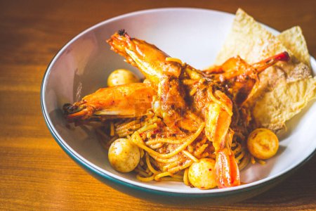 Photo for Laksa Pasta with Tiger King Prawn, quail egg, spicy coconut milk and spaghetti served in bowl - Royalty Free Image