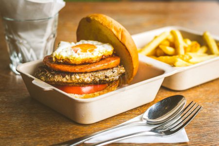 Photo for Champion Burger with Beef patty, chicken luncheon meet, sunny side up egg - Royalty Free Image