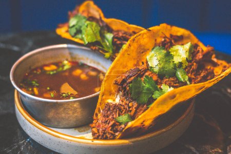 Beefy Birria Tacos made using 8 hour slow cooked chuck with beef consomme on the side