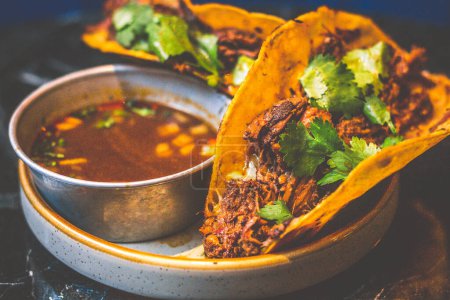 Photo for Beefy Birria Tacos made using 8 hour slow cooked chuck with beef consomme on the side - Royalty Free Image