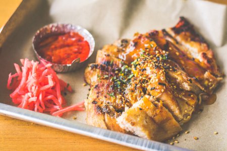 Photo for A La Carte Grilled Pork Cheek served with pickled ginger and chilli sauce - Royalty Free Image