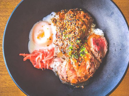 Photo for Beef Tenderloin Rice Bowl with onsen half boiled egg and pickled ginger - Royalty Free Image