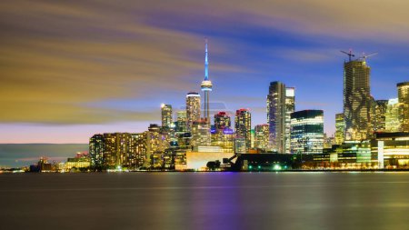 Téléchargez les photos : Toronto, Canada. Vue sur les gratte-ciel et la tour CH. Vue du centre-ville le soir. Illumination nocturne de la ville. La ville au bord du lac. Paysage urbain au coucher du soleil. - en image libre de droit