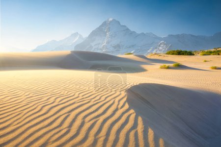 Photo for Nature. Sand dunes in the evening and mountains among the clouds. Summer landscape in the desert. Hot weather. Lines in the sand. Mountain range through the fog. - Royalty Free Image