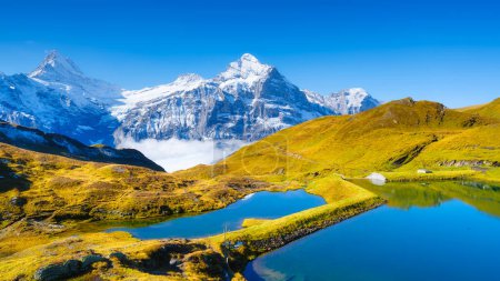 Bachalpsee, Grindelwald, Switzerland. Hiking and traveling in the mountains. Swiss classic landscape. Mountain valley with lake.