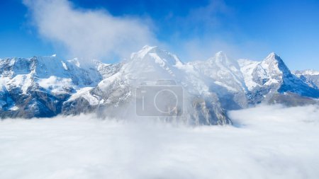 Photo for Natural background. Mountains and clouds in the valley. Natural landscape high in the mountains. Mountain range through the clouds. - Royalty Free Image