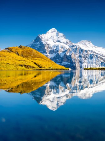 Photo for Swiss landscape. High mountains and reflection on the surface of the lake. Mountain valley with lake. Landscape in the highlands in the summertime. Travel and vacation. - Royalty Free Image