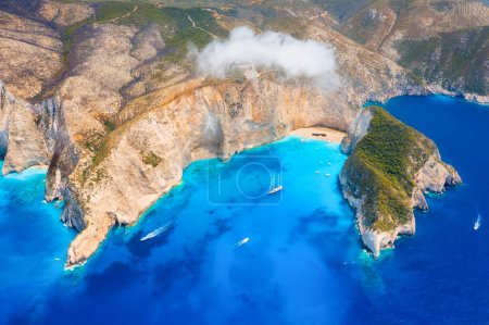 View of Navagio beach, Zakynthos Island, Greece. Aerial landscape. Azure sea water. Top view from a drone. Summer time for sea travel. The sea bay. Photo for background and wallpaper.