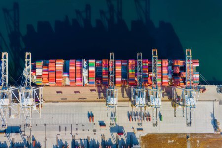Photo for Cargo commercial port. View from a drone. Containers for transporting goods. Cargo sea transport. View from above. Loading the ship containers.  Industry and trade. - Royalty Free Image
