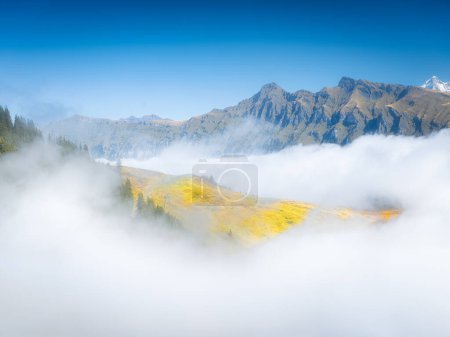 Photo for Mountain landscape. View of a high mountain in a valley. Huge sharp rocks and clouds. Landscape in summer time. A place for rock climbing and trekking. Photo for design and wallpaper. - Royalty Free Image