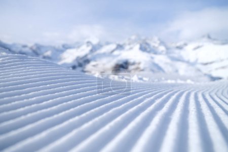 Photo for Snow slope for skiing and snowboarding. Velvet. Winter sports. Slope and mountains. Composition in winter time. Wallpaper and background. - Royalty Free Image