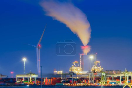 Photo for A view of the industrial district. Seaport and containers. Wind generator. Heavy industry. Emissions into the atmosphere. Photo for background, advertising and wallpaper. - Royalty Free Image