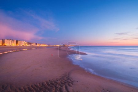 Ostend, Belgium. Panoramic view of the sea coast during sunset. Real estate on the coast. Long exposure. General view of the city.