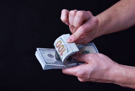 Mann hält rund 10000 US-Dollar, 100-Dollar-Banknoten. 