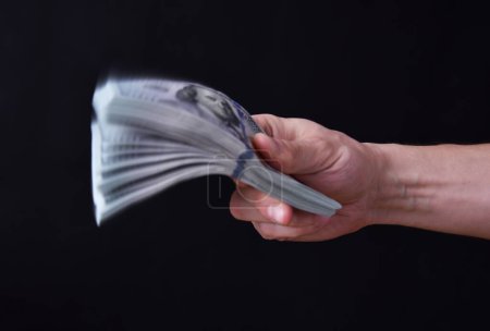 Photo for Man holding around 10000 american dollars, 100 USD banknotes. - Royalty Free Image