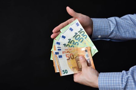 Photo for Businessman holding banknotes in his hand. Cash, Euro money.c - Royalty Free Image