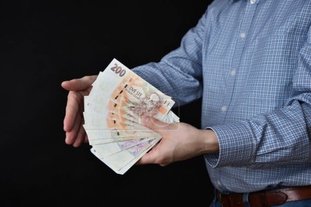 Photo for Businessman holding banknotes in his hand. Czech Republic cash. - Royalty Free Image