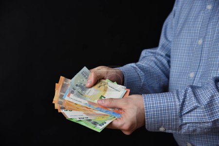 Photo for Businessman holding banknotes in his hand. Cash, Euro money.c - Royalty Free Image