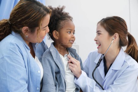 Young female doctor health examination to kid patient in the hospital