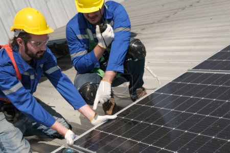 Téléchargez les photos : Ingénieurs ou travailleurs installent et inspectent la cellule solaire sur le toit de l'usine. - en image libre de droit