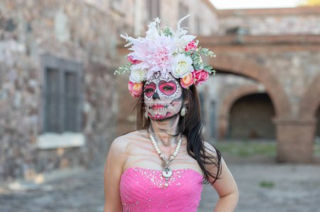 Photo for Portrait of a girl with sugar skull makeup over black background. Calavera Catrina. Dia de los muertos. Day of The Dead. Halloween. - Royalty Free Image
