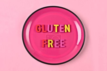 Photo for Gluten Free lettering on a pink plate. Nutritional concept. - Royalty Free Image