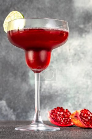 Photo for Glass of Pomegranate Margarita Cocktail on gray background - Royalty Free Image