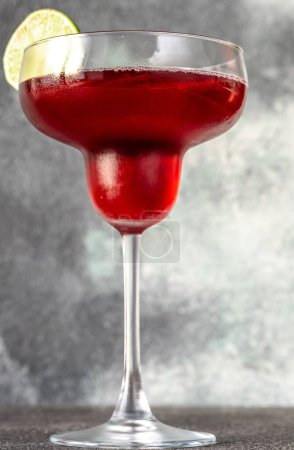 Photo for Glass of Pomegranate Margarita Cocktail on gray background - Royalty Free Image